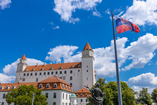 Bratislava, Slovakia - 05.05.2025: Slovakia and EU flags waving near President's palace on the square of slovak capital Bratislava. National and European symbols in city center of European city