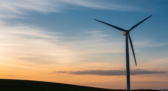 Renewable energy concept of a wind turbine generating power against a vibrant sunset sky, symbolizing clean electricity and sustainable future growth