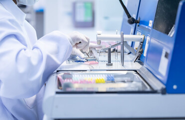 Laboratory technician conducting analysis with advanced equipment in a clean room environment during work hours