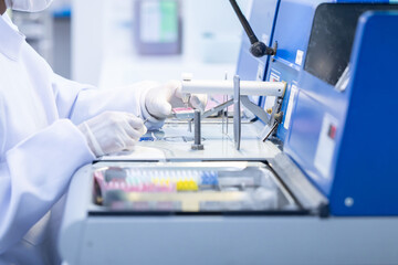 Laboratory technician conducting analysis with advanced equipment in a clean room environment during work hours