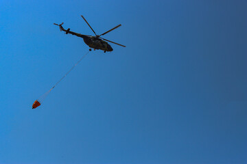 The turkey A helicopter is flying in the sky.is standing in the yard.