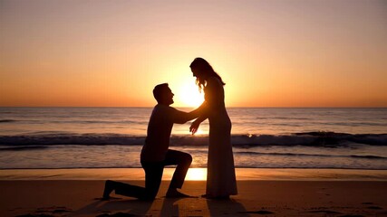 Silhouette of a man proposing to a woman on the beach at sunset with ocean waves in the background