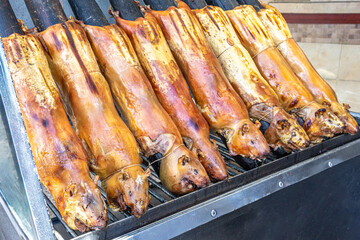Typical food of Ecuador: guinea pig roasting on the grill, prepared with traditional Andean techniques that preserve cultural essence and offer a unique gastronomic experience.