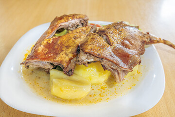Traditional dish of guinea pig chili or roasted guinea pig, a typical Ecuadorian dish, served with Andean ingredients that highlight the richness, culture, and authentic flavors of Ecuadorian cuisine.