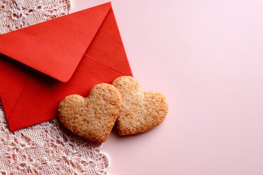 Heart-shaped Cookies and a Red Envelope on a Soft Background