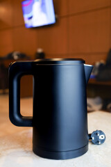 Minimalist Black Modern Electric Kettle Appliance in Kitchen Setting