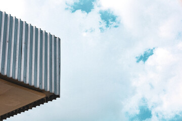 Minimalist Architecture Corrugated Metal Detail with Cloudscape Sky Background Image
