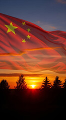 Chinese flag waving against a vibrant sunset sky with silhouette trees