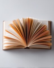 Open Book with Fanned Pages on Clean Background Surface