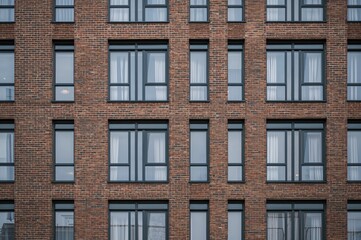 Close-up view of windows on a contemporary brick building facade.