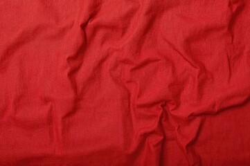 Wrinkled red linen cloth texture with space for text, close-up banner.