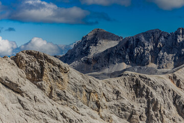 Alps mountains scenic landscape in summer. Austrian Alps scenery trekking path among the high mountain peaks in summer. Green mountain valleys with rocky peaks and lake in the Alps in Austria