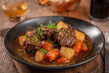 Dish featuring beef stew with potatoes and vegetables in a savory sauce