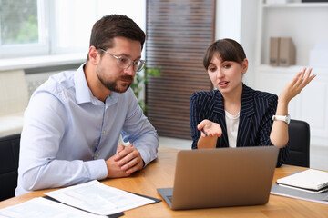 Consultant working with client at table in office. Business meeting