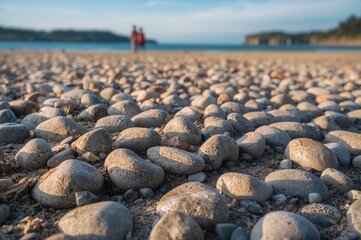 Obraz premium Layered pebbles stacked on a sandy shore
