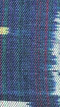 Handwoven ikat textile featuring colorful geometric patterns. Perfect for backgrounds, fashion, interior design, and cultural themes.