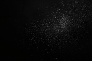 Genuine particles suspended in the atmosphere against a black backdrop
