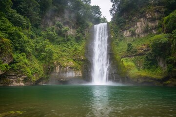 The most stunning waterfall surrounded by lush green forest after rain.