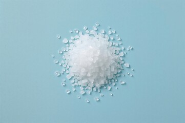 Common salt: essential seasoning and food preservative on a blue backdrop