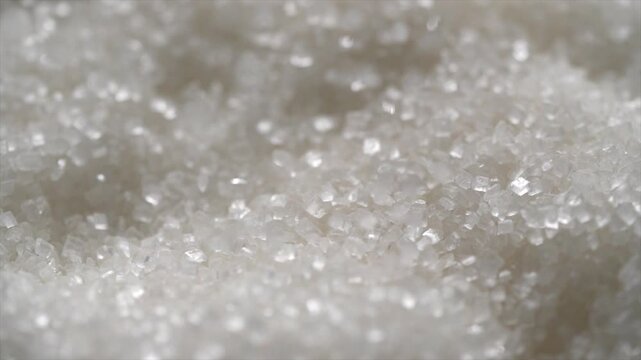 Macro video of sugar particles. close up texture of white sugar.