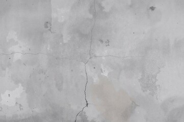 Obraz premium Detailed close-up of a rough concrete wall showing cracks and flaws