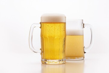 Chilled pale beer in a frosted glass on a plain backdrop