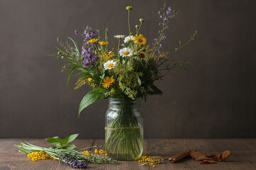 Rustic Display of Wildflowers and Herbs in a Jar on a Wooden Surface with Autumn Tones