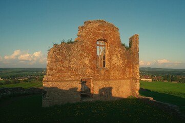 Ancient Crumbling Fortress Wall Illuminated by Sunlight Through an Opening