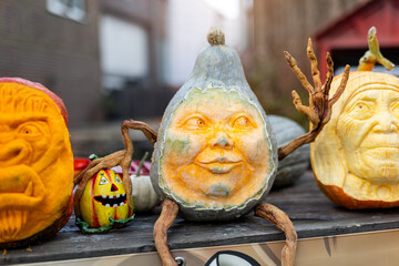 Carved pumpkins with expressive faces create imaginative Halloween decorations. Artistic designs range from spooky to humorous, turning seasonal vegetables into festive sculptures