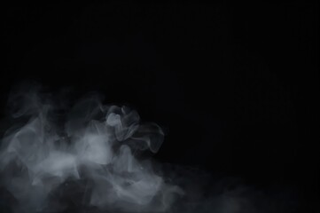 Unclear white mist against a dark, blank backdrop with space for text, depicting active steam.