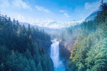 Scenic cascade beside a mountain path in a snowy forest with ice and blue skies