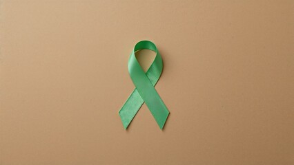 Mental health awareness day theme featuring a green ribbon on recycled brown paper