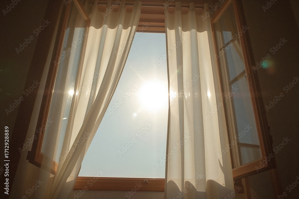 Poster breeze flowing through an open window with sunlight illuminating the curtains