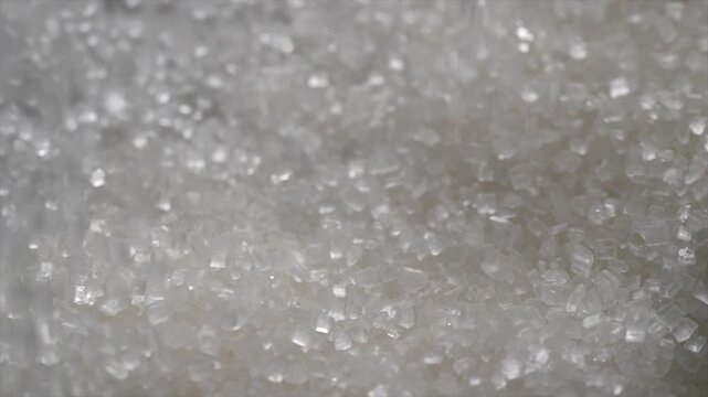 Macro video of white sugar particles. Close up texture of sugar.