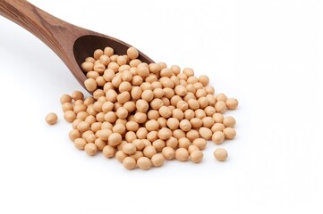 Soybeans cascading from a wooden spoon against a white backdrop
