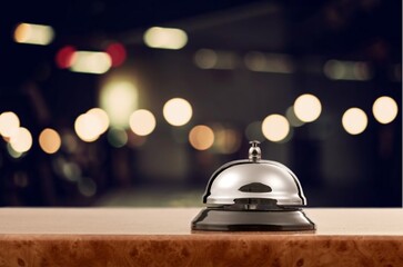 Steel concierge bell on cozy hotel lounge