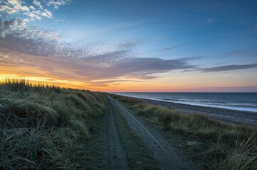 A coastal area by the sea featuring stunning sunsets ideal for beach and dune walks.