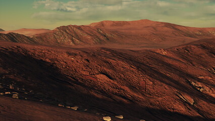 Fototapeta premium A breathtaking red landscape stretches across the horizon with rugged mountains in the distance. The vivid colors showcase the beauty of nature under a bright, clear sky at sunset.