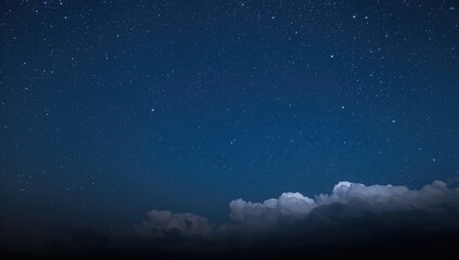 Fototapeta premium Night sky filled with stars and clouds