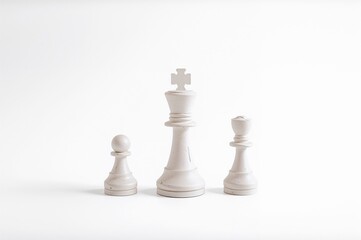 Isolated set of three white wooden chess figures on a white background