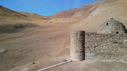 Aerial drone view of the ancient Tash Rabat caravanserai, built in the 15th century. Located in the mountains of the Tien Shan at an altitude of over 3500 m above sea level.