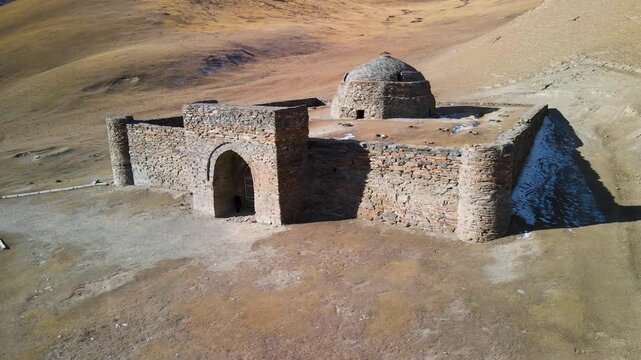 Aerial drone view of the ancient Tash Rabat caravanserai, built in the 15th century. Located in the mountains of the Tien Shan at an altitude of over 3500 m above sea level.