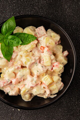Potato salad ham, potato, tomato, carrot, mayonnaise tasty snack fresh delicious gourmet food background on the table rustic top view copy space