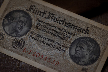 Ancient german banknote german fnf reichsmark banknote and small pouch evokes historical finance from old germanys era.
