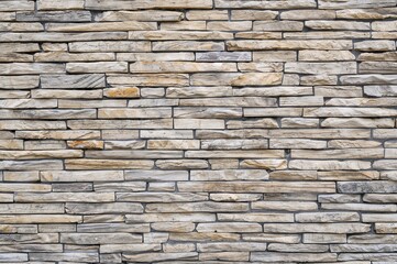 Fototapeta premium Background featuring a robust and attractive stone accent wall
