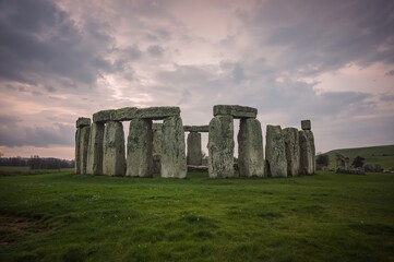 Ancient Monument Amidst Overcast Skies with Grass and Landscape