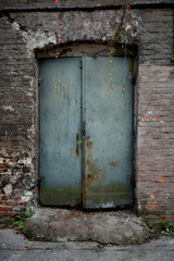 Old rusty metal door on wall