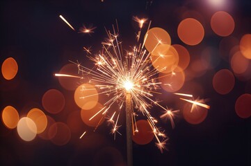 Close-up of a glowing sparkler with numerous sparks and a blurred background