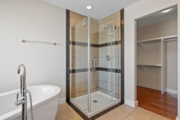 Bathroom with a white tub and a shower stall