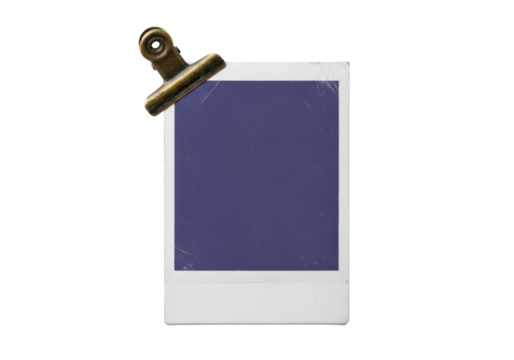 Vertically oriented instant photo card with muted grey border, blank indigo rectangle, worn edges, and weathered brass clip on transparent background, minimalist still life concept